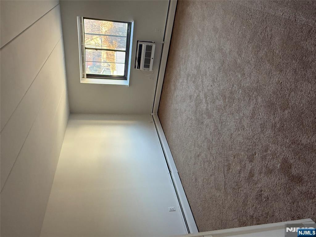 873 Main Street, Unit 2E Hackensack, NJ 07601 - Photo 12 of 14 an empty room with windows