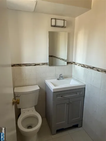a bathroom with a sink toilet and mirror