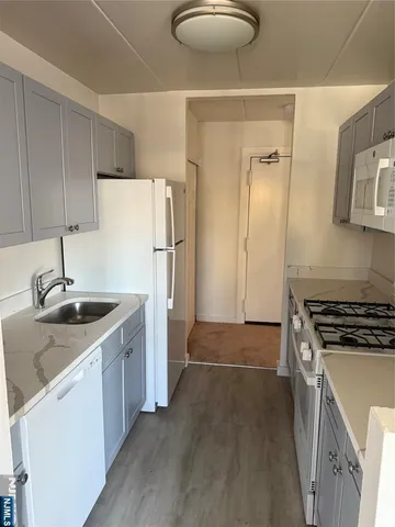 a kitchen with a sink a stove and refrigerator