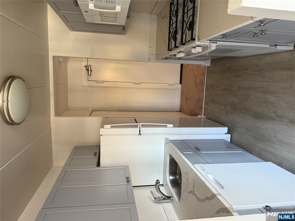 873 Main Street, Unit 2E Hackensack, NJ 07601 - Photo 3 of 14 a kitchen with a sink a stove and refrigerator