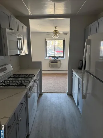a kitchen with granite countertop a sink stove and refrigerator