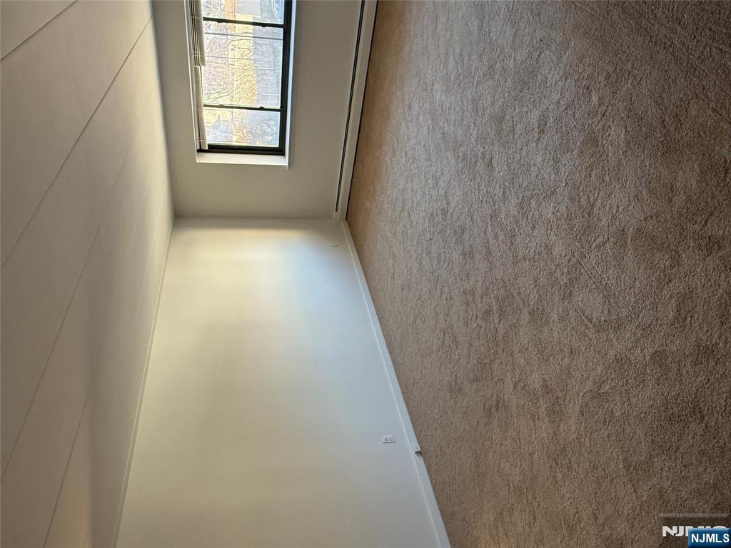 873 Main Street, Unit 2E Hackensack, NJ 07601 - Photo 5 of 14 wooden floor in an empty room with a window