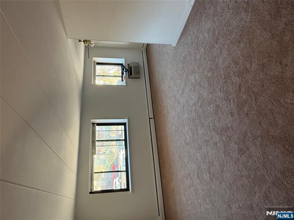 873 Main Street, Unit 2E Hackensack, NJ 07601 - Photo 7 of 14 an empty room with windows