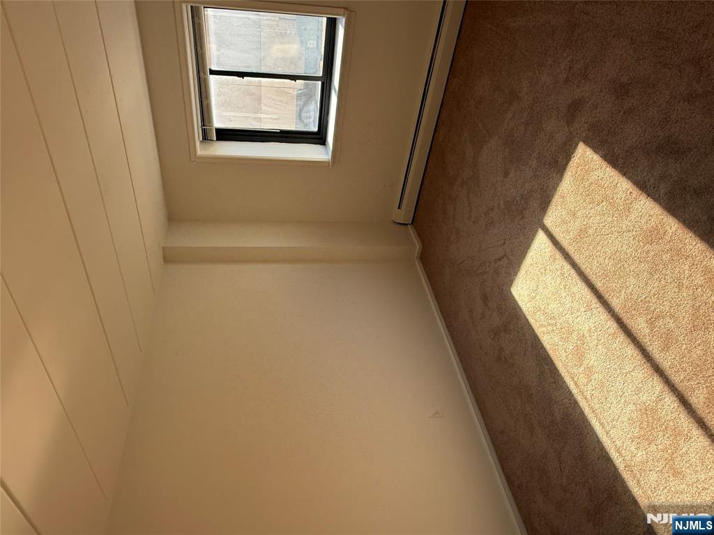 873 Main Street, Unit 2E Hackensack, NJ 07601 - Photo 9 of 14 a view of an empty room and window