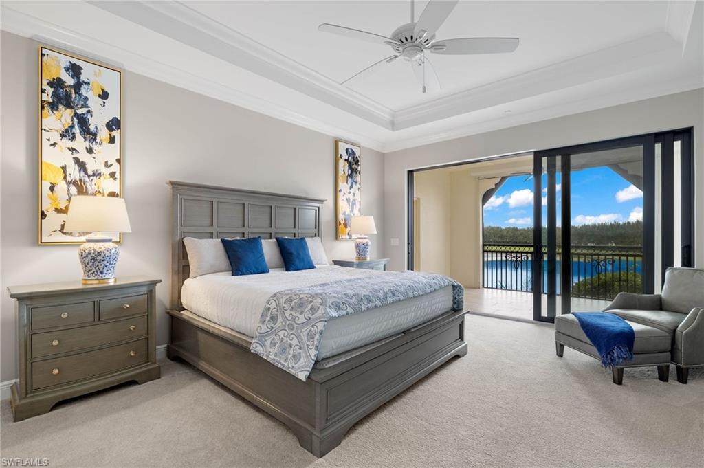 16449 Carrara Way, Unit 101 Naples, FL 34110 - Photo 13 of 35 Primary Bedroom with access to exterior, a tray ceiling, and ornamental molding.
