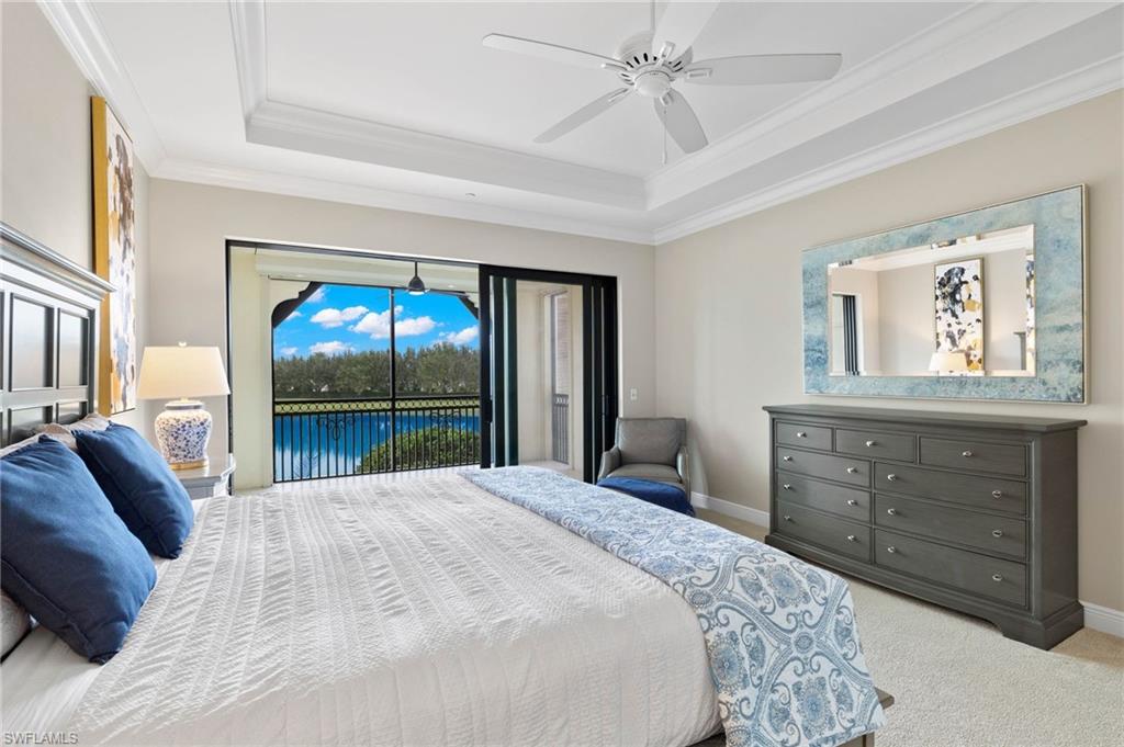 16449 Carrara Way, Unit 101 Naples, FL 34110 - Photo 14 of 35 Primary bedroom with a tray ceiling, access to lanai.