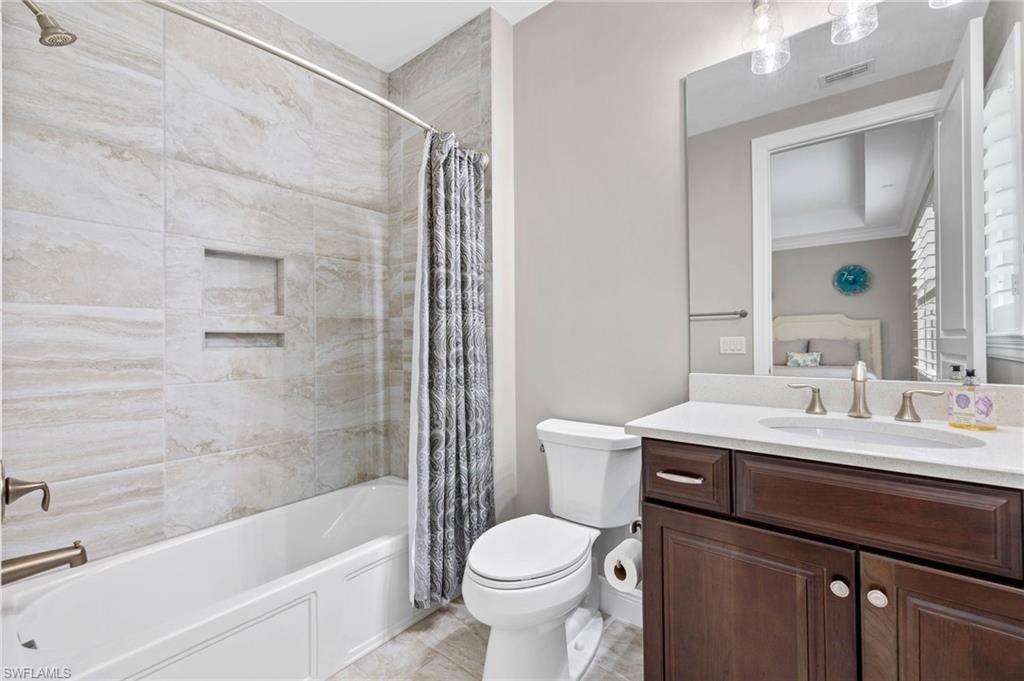 16449 Carrara Way, Unit 101 Naples, FL 34110 - Photo 22 of 35 Guest Bathroom 2 featuring shower/bath combo.