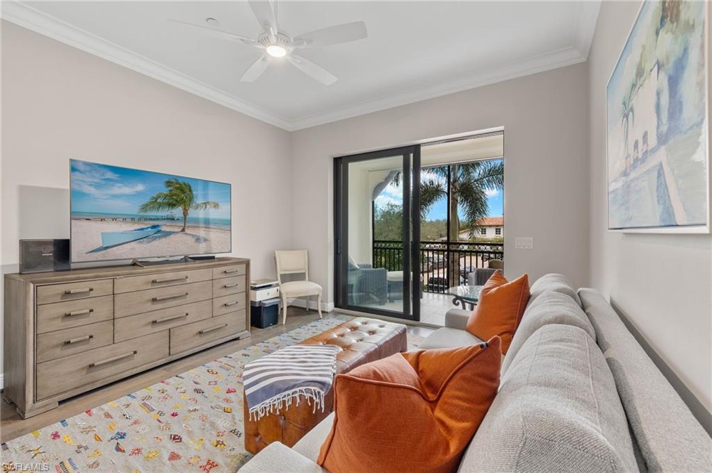 16449 Carrara Way, Unit 101 Naples, FL 34110 - Photo 23 of 35 Study/Den with wood plank flooring, a ceiling fan, crown molding, and access to its own lanai.