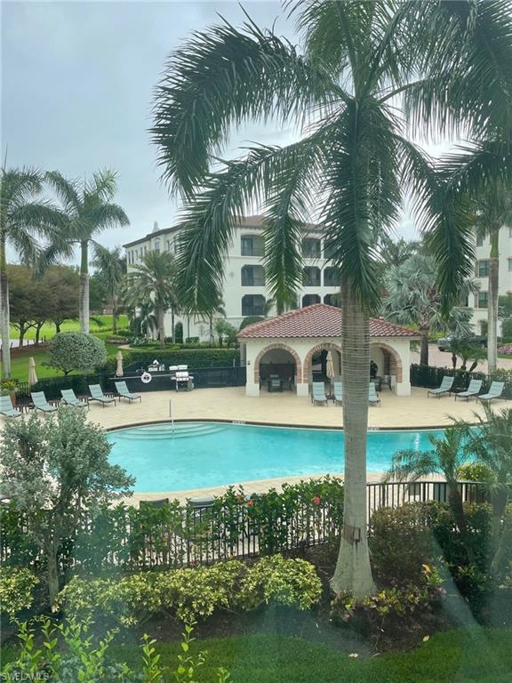 16449 Carrara Way, Unit 101 Naples, FL 34110 - Photo 27 of 35 Carrara Neighborhood Pool w/Spa and Gas Grills.