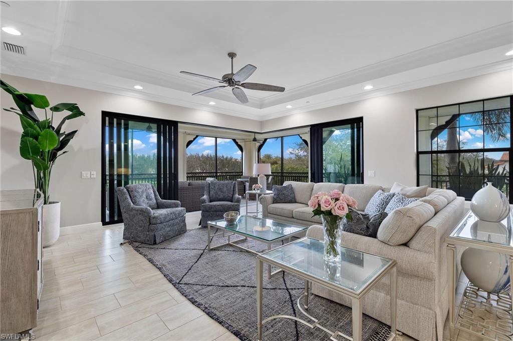 16449 Carrara Way, Unit 101 Naples, FL 34110 - Photo 3 of 35 Great Room area with crown molding, recessed lighting, and a ceiling fan.