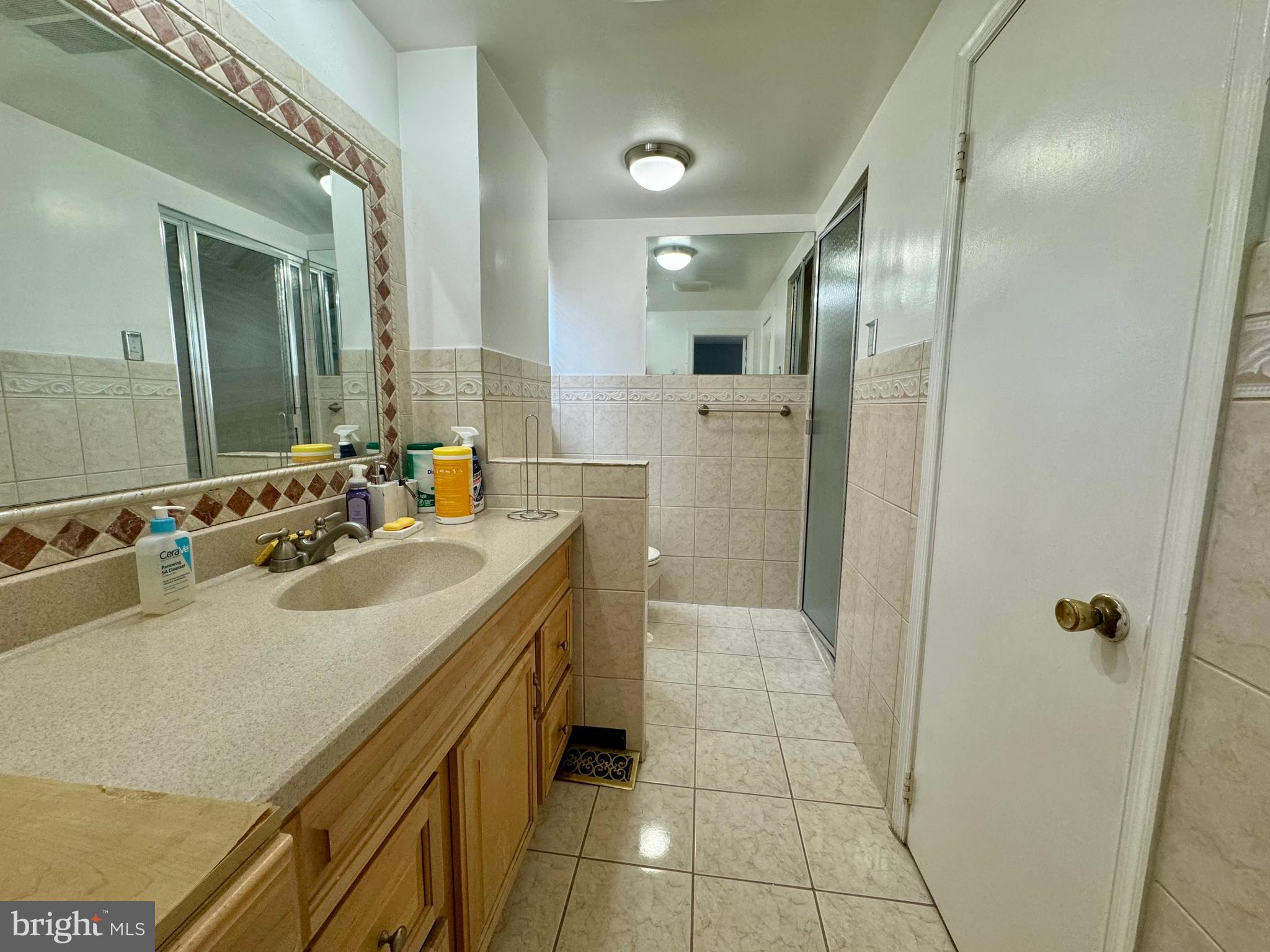10100 Galahad Road Philadelphia, PA 19116 - Photo 16 of 17 a bathroom with a sink double vanity and a mirror