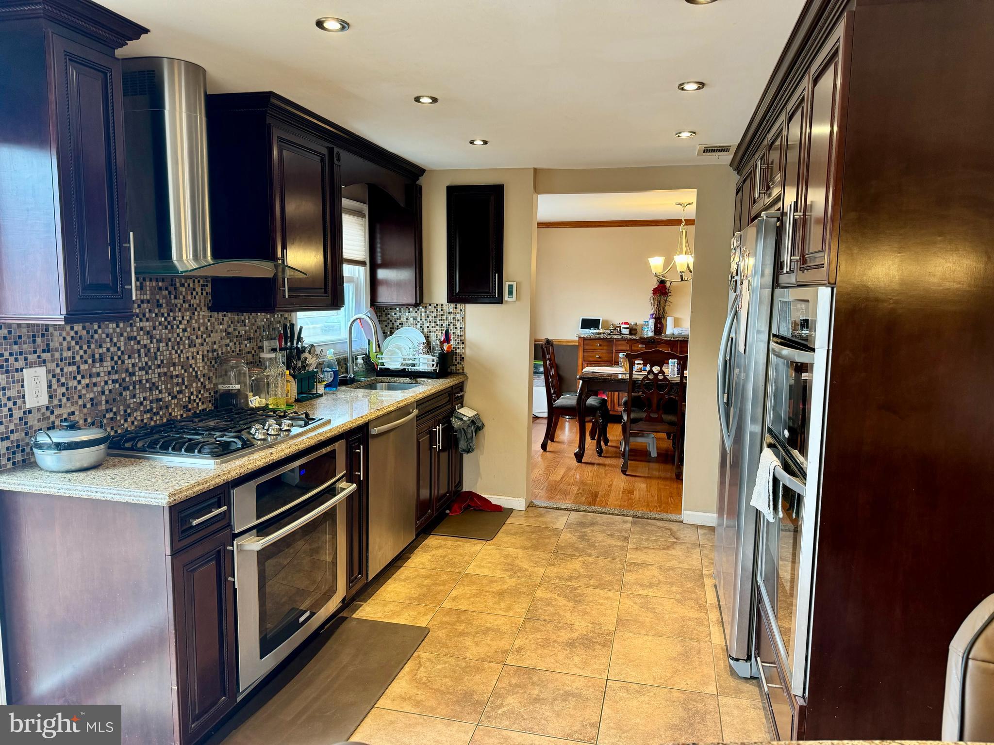 10100 Galahad Road Philadelphia, PA 19116 - Photo 10 of 17 a kitchen with stainless steel appliances granite countertop a stove and a sink