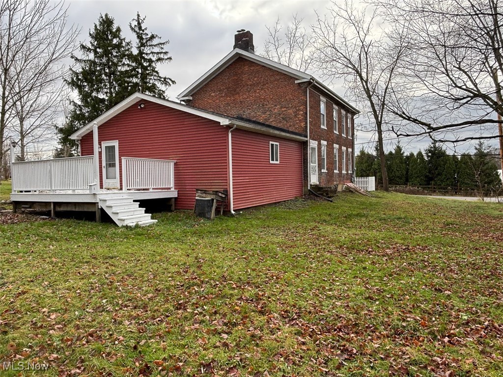 13250 Chardon-Windsor Road Chardon, OH 44024 - Photo 7 of 10 View of home's exterior with a wooden deck and a yard