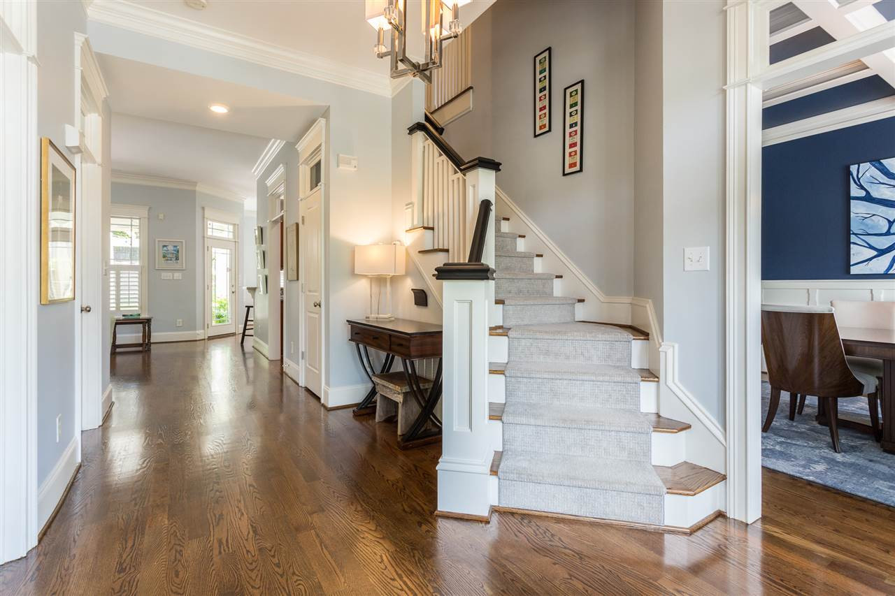 As soon as you walk into the home, you will be impressed with the crown molding, gorgeous hardwood floors, and the flowing hallway that beckons you to the family room and kitchen. Graceful Architecture and Exceptional Craftsmanship