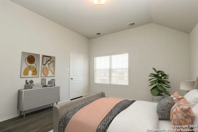 a bedroom with a bed and a couch