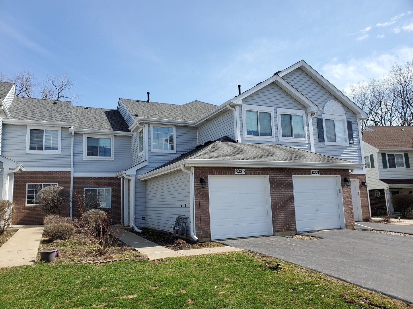 8225 Ripple Ridge, Unit 8225 Darien, IL 60561 - Photo 1 of 21 a front view of a house with a yard and garage