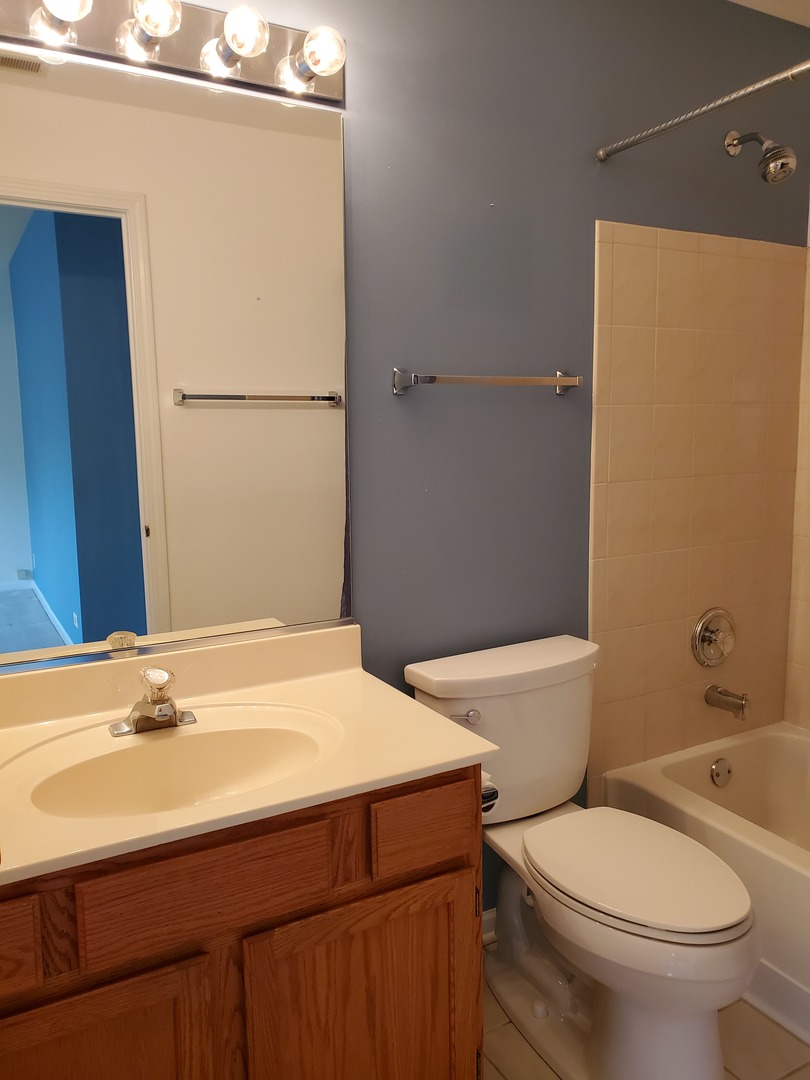 8225 Ripple Ridge, Unit 8225 Darien, IL 60561 - Photo 14 of 21 a bathroom with a sink a toilet and shower