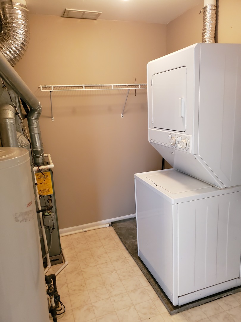 8225 Ripple Ridge, Unit 8225 Darien, IL 60561 - Photo 17 of 21 a utility room with dryer and washer