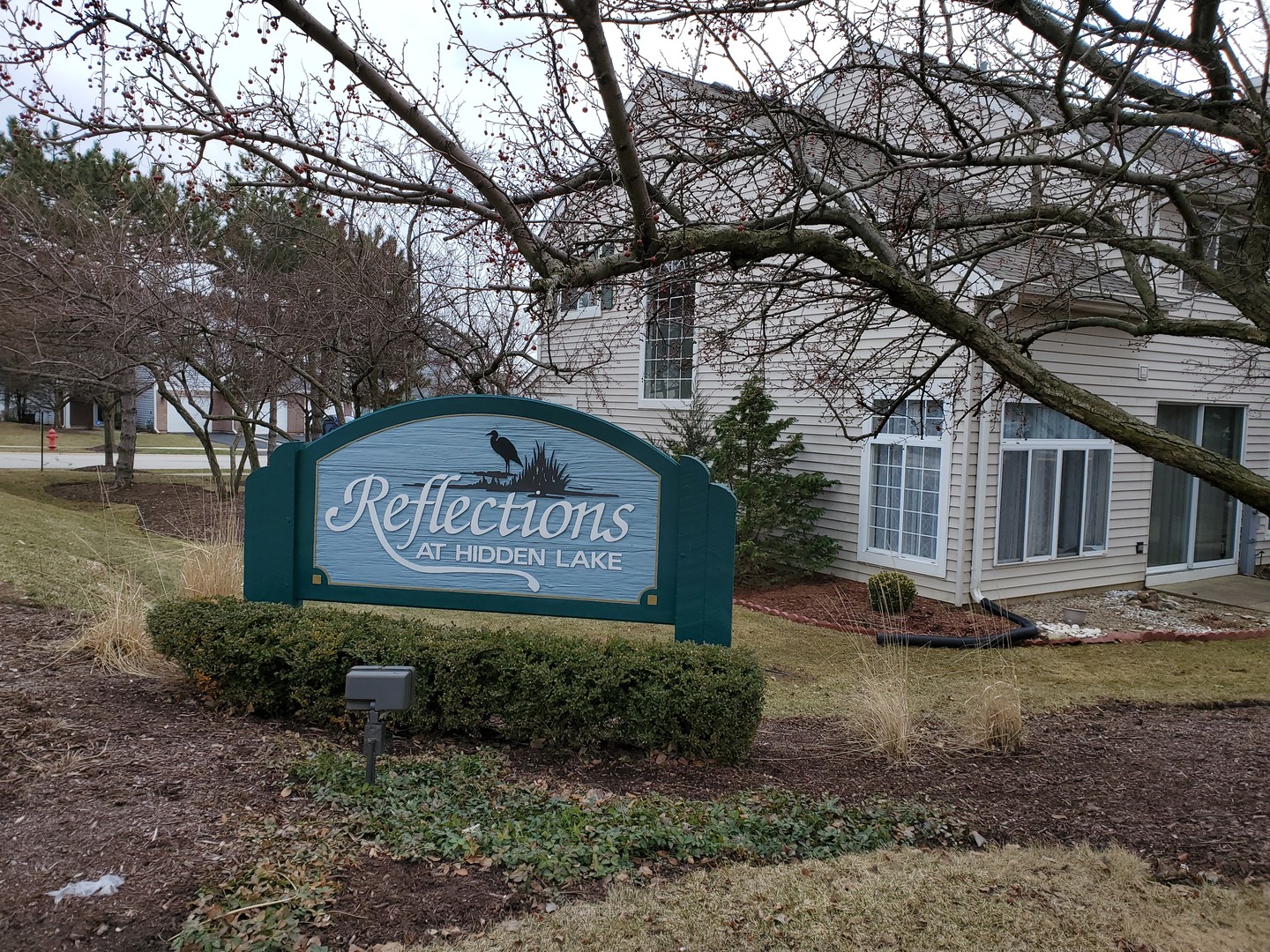 8225 Ripple Ridge, Unit 8225 Darien, IL 60561 - Photo 20 of 21 a sign board with a building in the background
