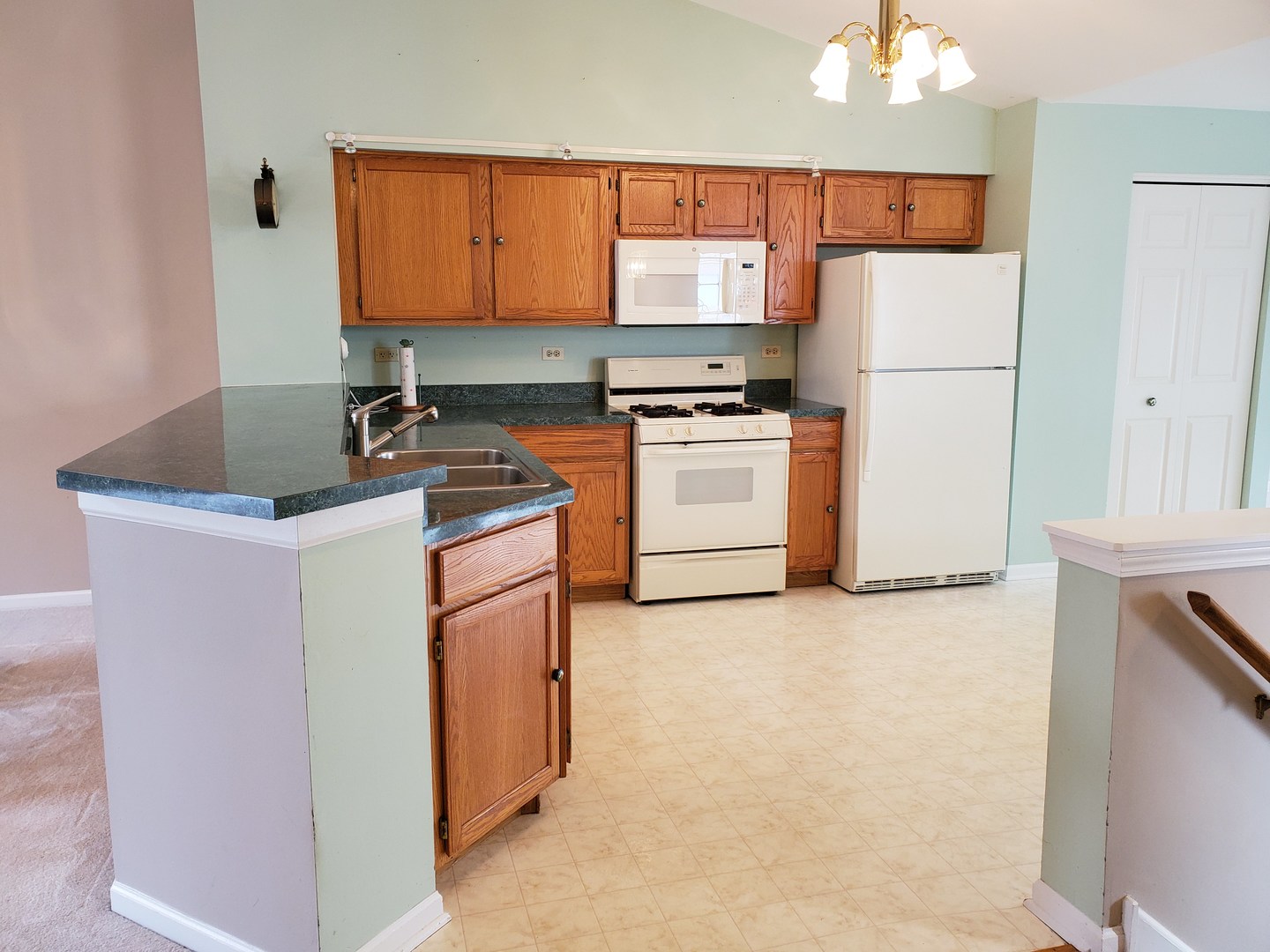 8225 Ripple Ridge, Unit 8225 Darien, IL 60561 - Photo 4 of 21 a kitchen with a refrigerator sink stove and cabinets