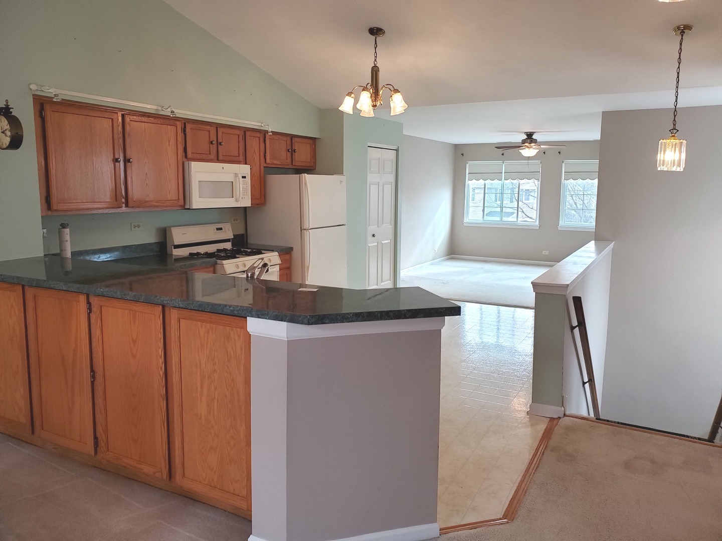 8225 Ripple Ridge, Unit 8225 Darien, IL 60561 - Photo 5 of 21 a kitchen with granite countertop a sink a stove and cabinets