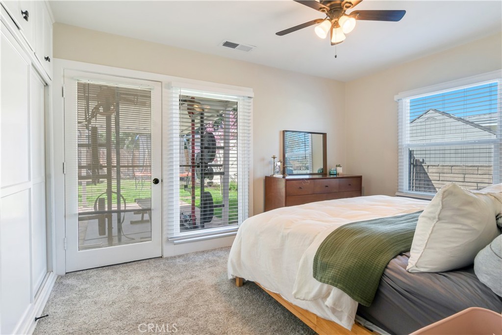 6755 Rainier Court Riverside, CA 92506 - Photo 12 of 23 a bedroom with a bed and a chandelier