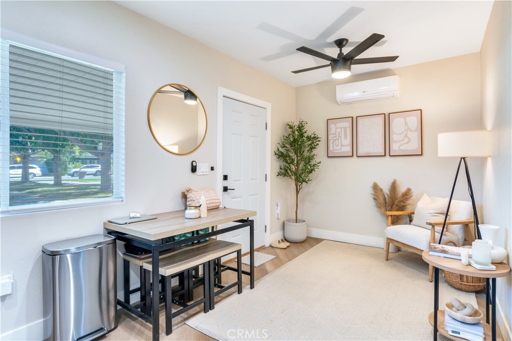 6755 Rainier Court Riverside, CA 92506 - Photo 21 of 23 a living room with a table chairs and a window