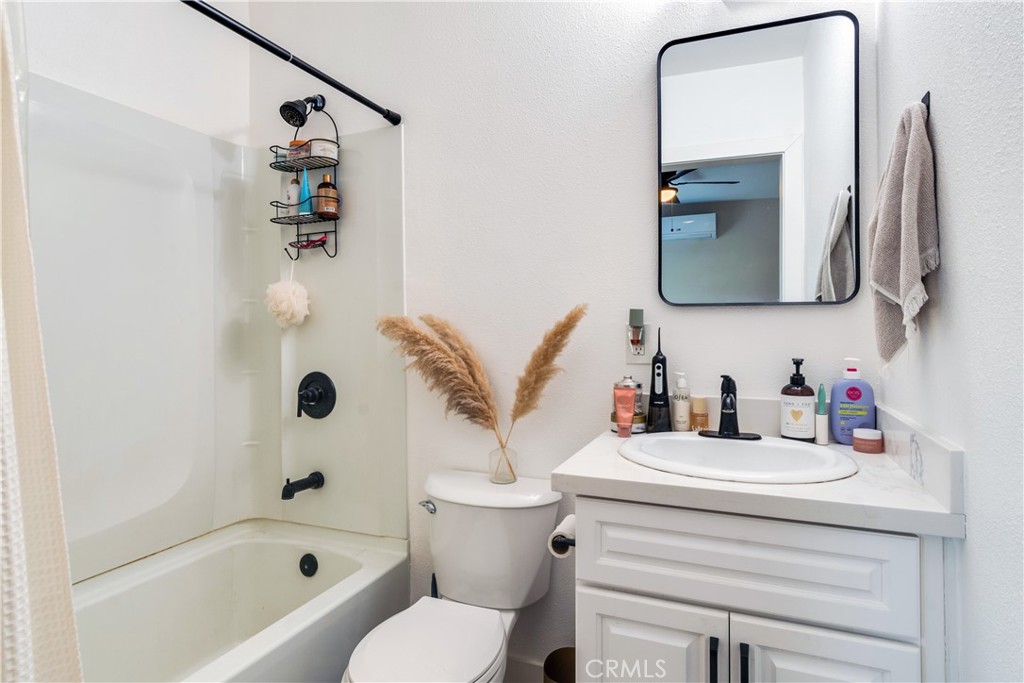 6755 Rainier Court Riverside, CA 92506 - Photo 23 of 23 a bathroom with a bathtub sink vanity mirror and toilet