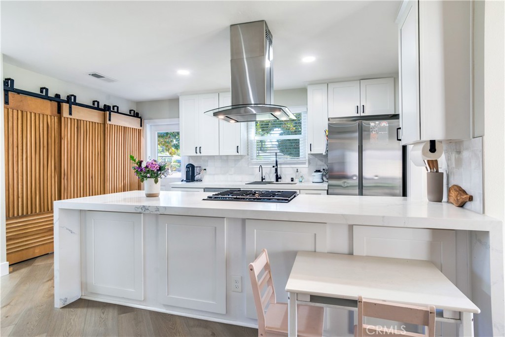 6755 Rainier Court Riverside, CA 92506 - Photo 4 of 23 a kitchen with stainless steel appliances a sink stove and refrigerator