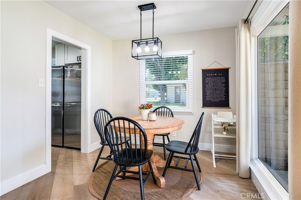 6755 Rainier Court Riverside, CA 92506 - Photo 10 of 23 a dining room with furniture a chandelier and wooden floor