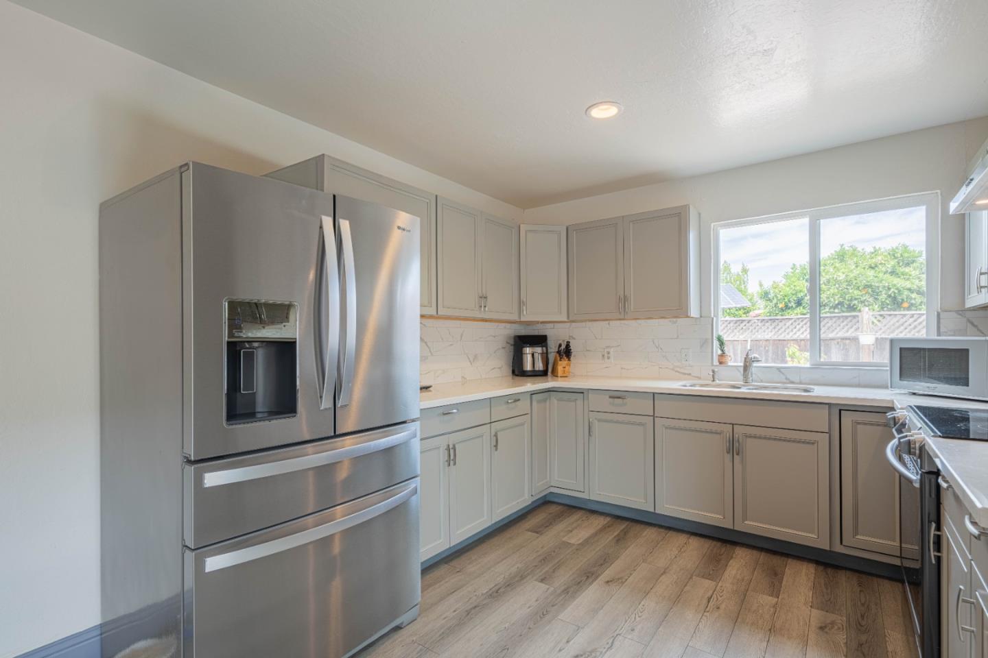 8340 Forest Street Gilroy, CA 95020 - Photo 13 of 30 a kitchen with white cabinets and white appliances
