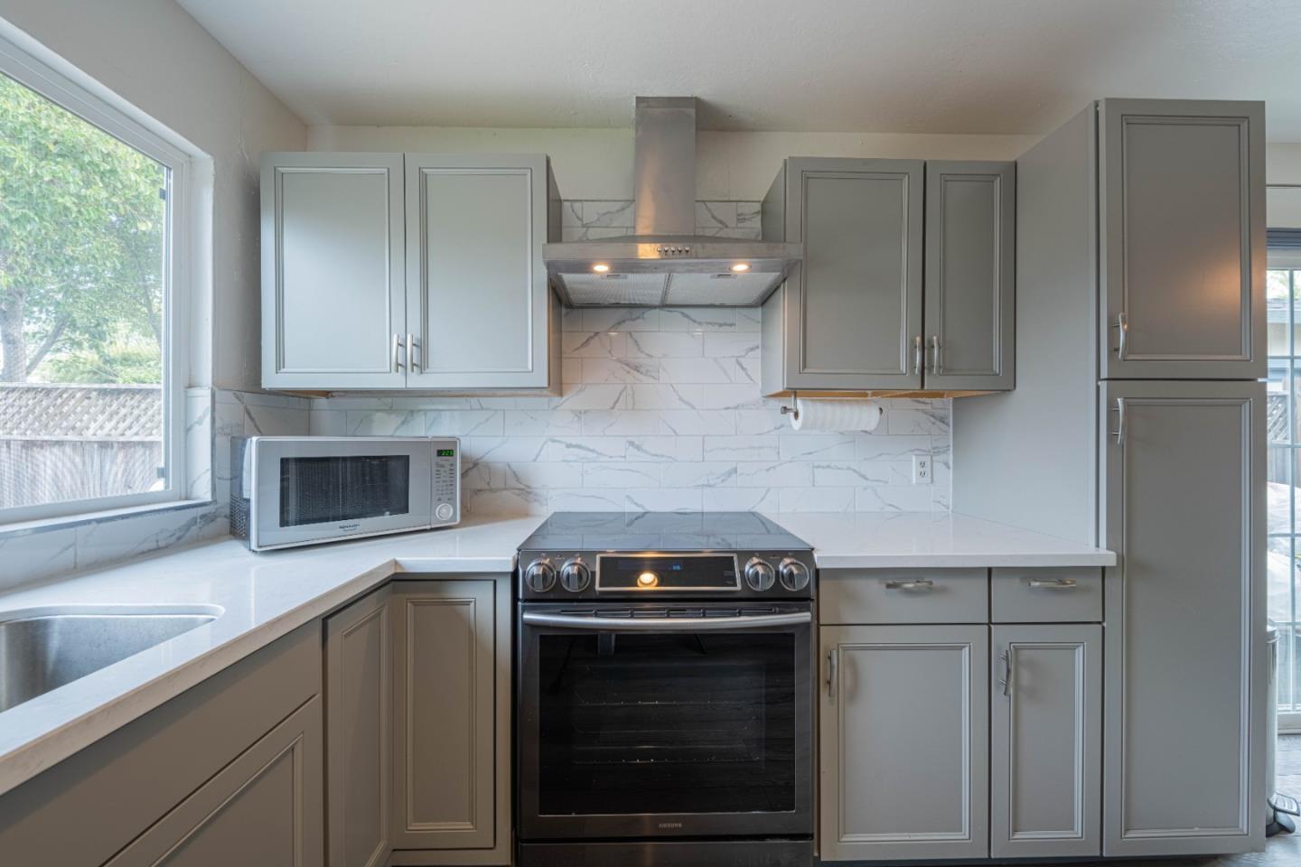 8340 Forest Street Gilroy, CA 95020 - Photo 14 of 30 a kitchen with stainless steel appliances wooden cabinets and a stove top oven