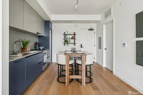 a bedroom with a bed and large windows