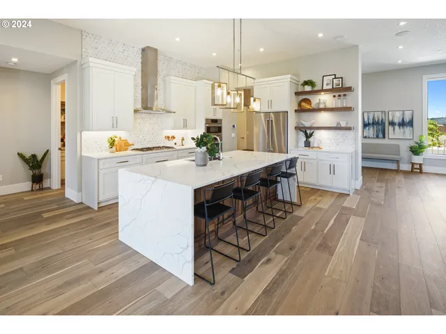 a kitchen with wooden floors and appliances