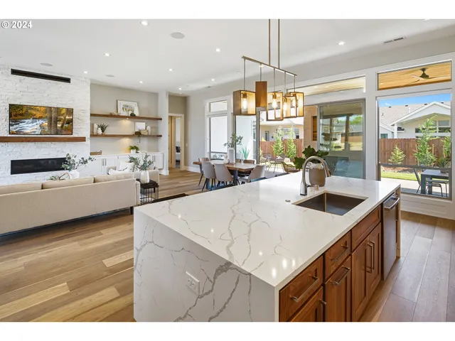 a kitchen with a sink a stove and chairs