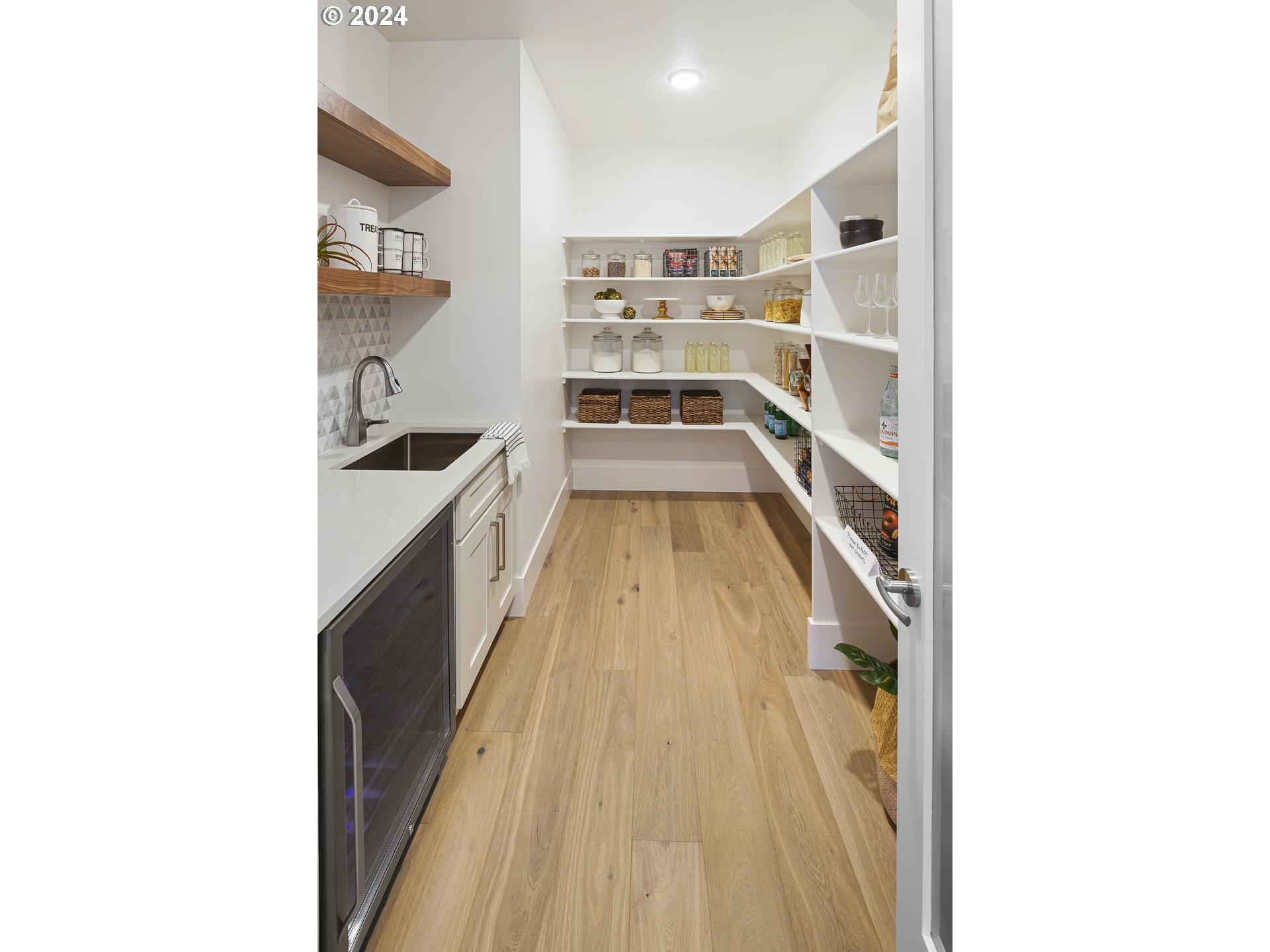 17711 Northeast 25th Avenue, Unit LOT 8 Ridgefield, WA 98642 - Photo 16 of 39 a hallway with a white cabinets and wooden floor