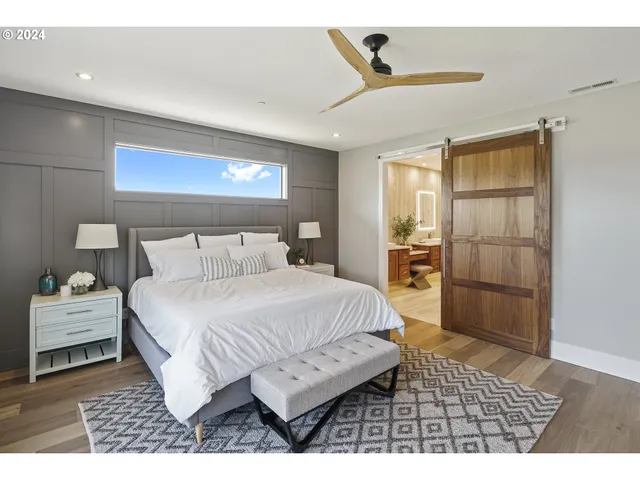 a bedroom with a bed and a view of kitchen