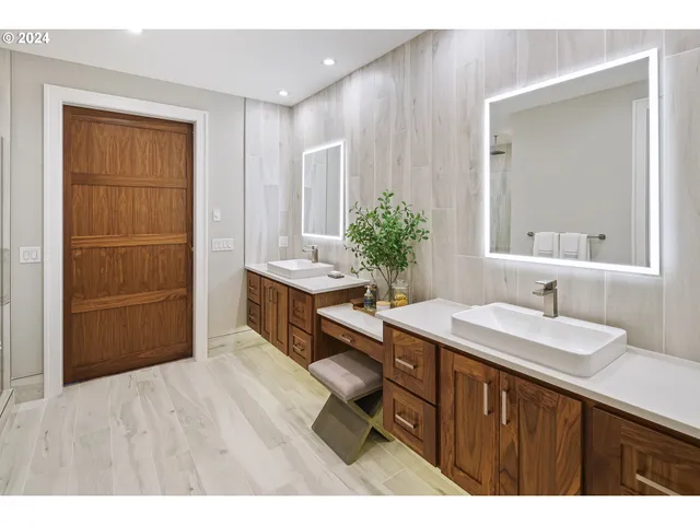 a en suite bathroom with a sink a mirror and a shower