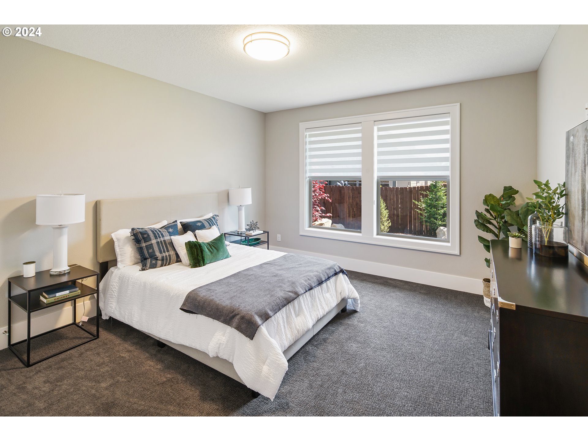 17711 Northeast 25th Avenue, Unit LOT 8 Ridgefield, WA 98642 - Photo 26 of 39 a living room with a bed furniture and a potted plant