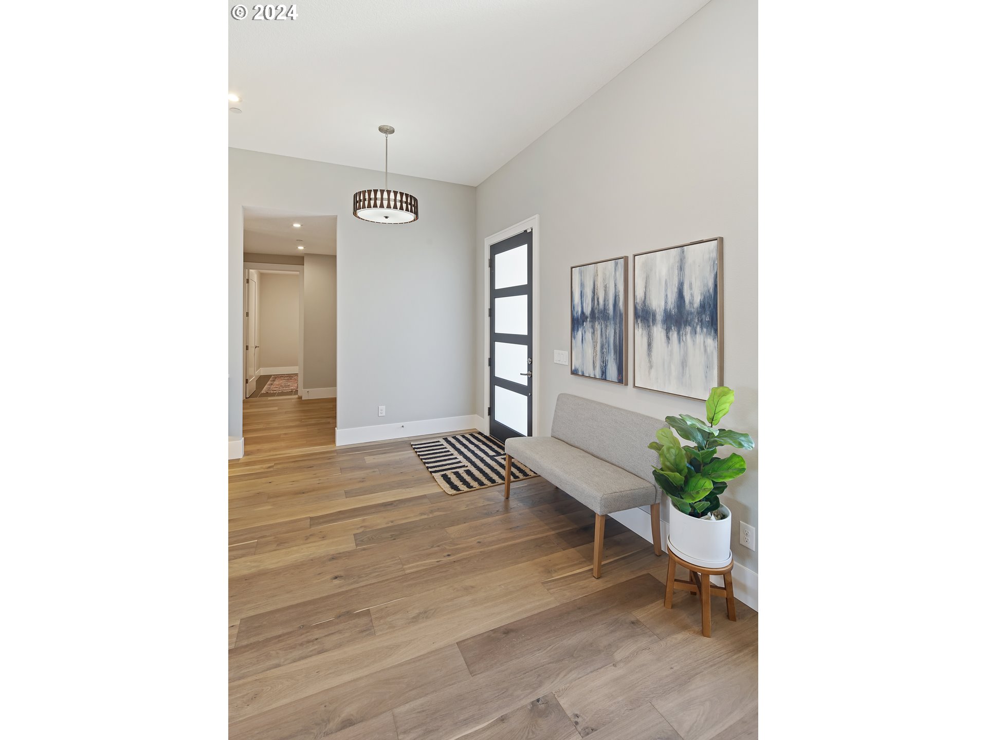 17711 Northeast 25th Avenue, Unit LOT 8 Ridgefield, WA 98642 - Photo 29 of 39 a view of a hallway with wooden floor and a potted plant