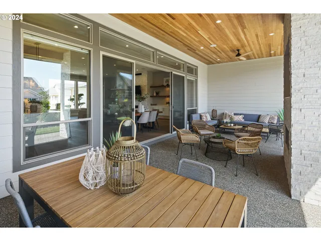 a backyard of a house with table and chairs