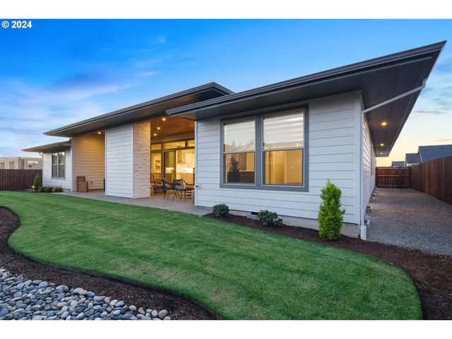 a front view of a house with a garden