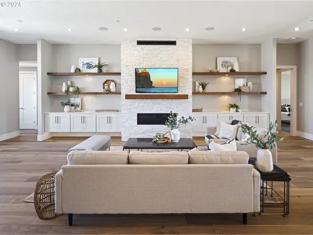 a living room with furniture a fireplace and a flat screen tv
