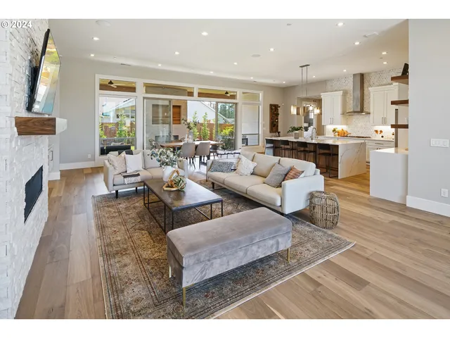 a living room with fireplace furniture and a wooden floor