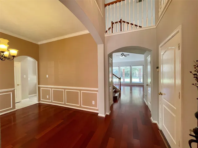 a view of a hallway view with wooden floor and staircase