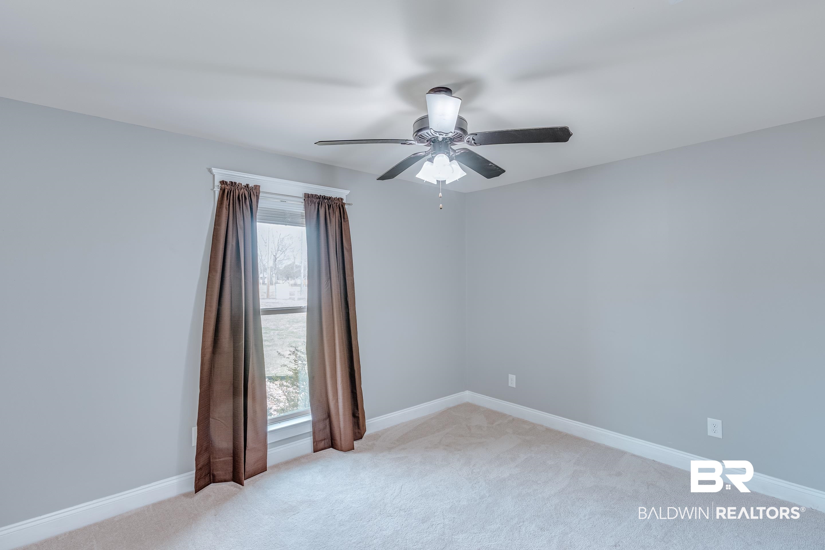 13235 Tom Gaston Road Mobile, AL 36695 - Photo 22 of 43 Spare room featuring light carpet and ceiling fan