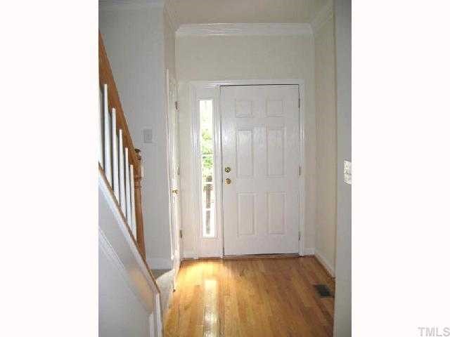5406 Goldenglow Way Raleigh, NC 27606 - Photo 2 of 12 a view of a hallway with wooden floor