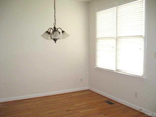 5406 Goldenglow Way Raleigh, NC 27606 - Photo 4 of 12 a view of a small space with wooden floor and a window