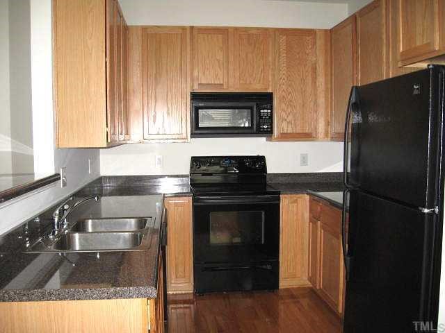 5406 Goldenglow Way Raleigh, NC 27606 - Photo 5 of 12 a kitchen with a refrigerator stove and microwave