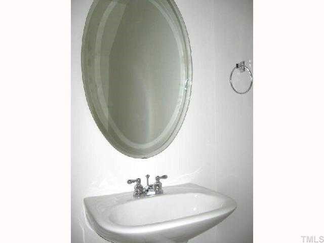 5406 Goldenglow Way Raleigh, NC 27606 - Photo 6 of 12 a bathroom with a sink and a mirror